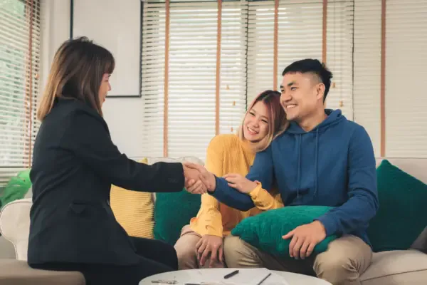 happy-young-asian-couple-realtor-agent
