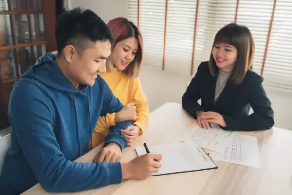 happy-young-asian-couple-realtor-agent-sign-document
