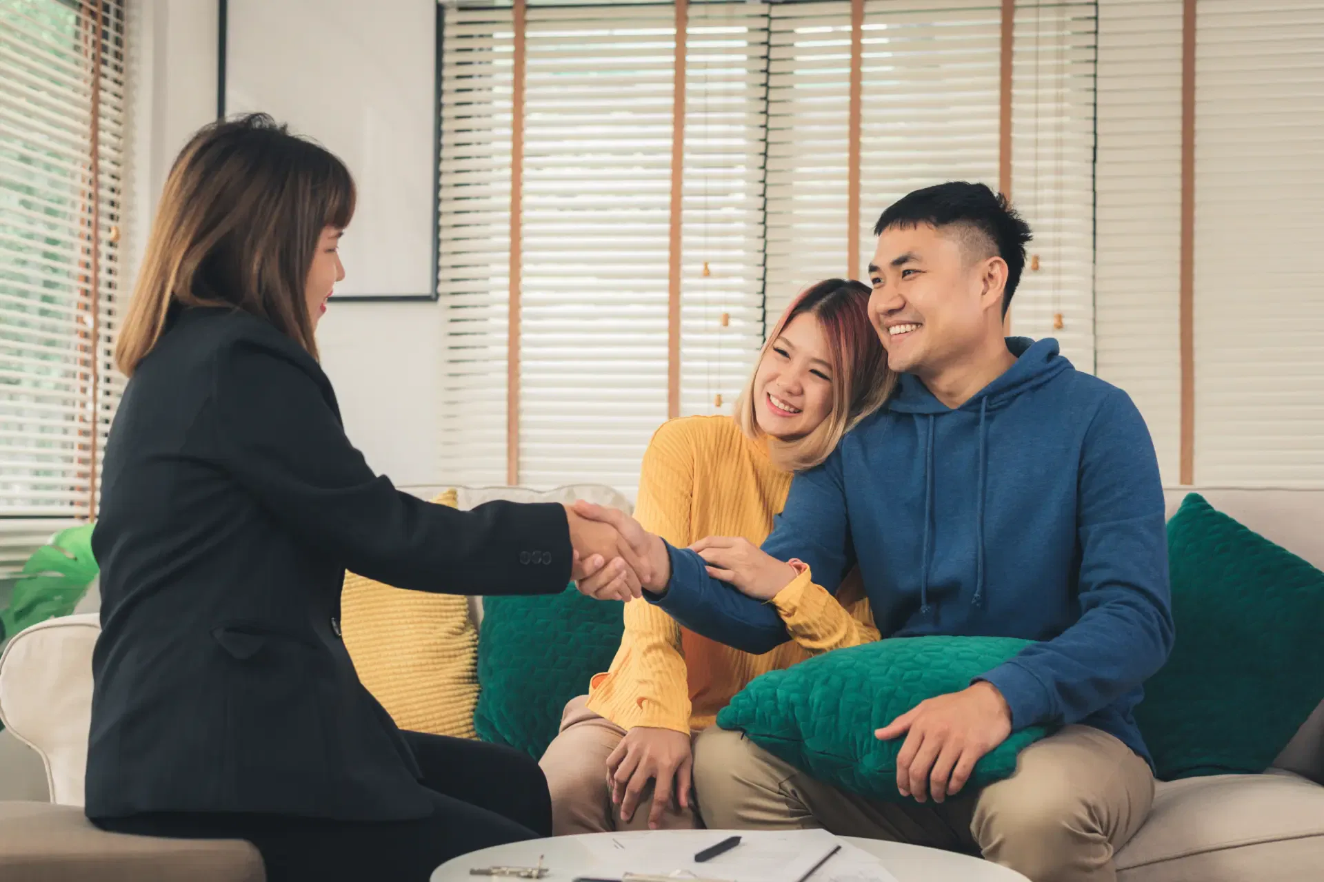 happy-young-asian-couple-realtor-agent